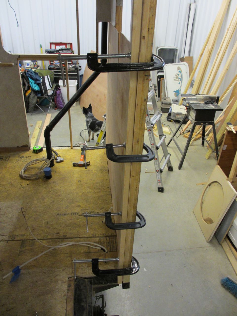  Clamps held the luan against the beams overnight to ensure it was glued tightly. 