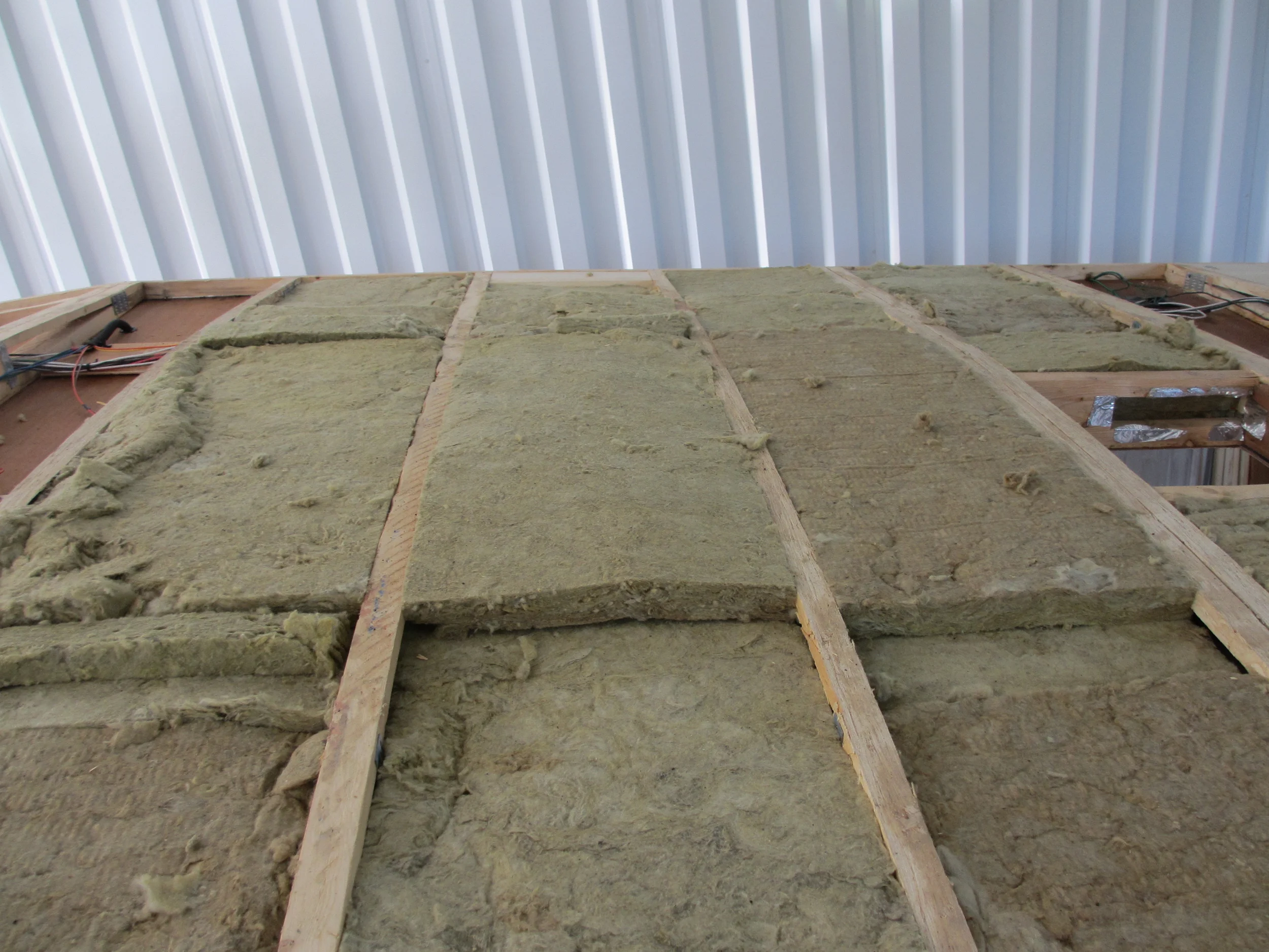 Mineral wool insulation layered on the roof.