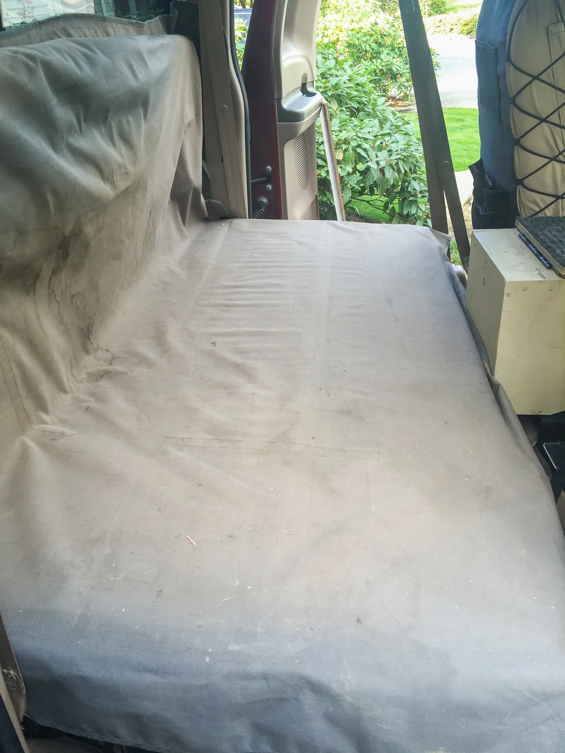 What the back seats look like folded flat. We placed a dog car seat cover over it for protection.