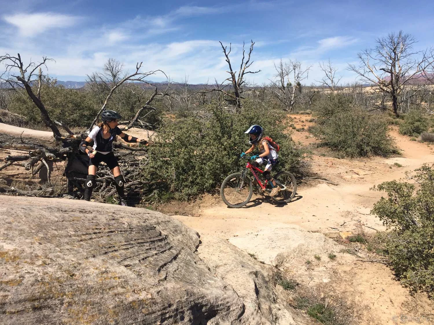 Jennifer spotting Ellie on a section of trail that the kids sessioned.