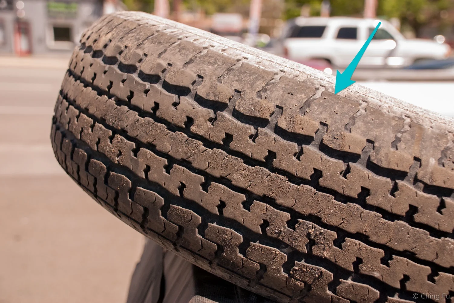 One of our rear axle's tires. It has less than 20k miles on it. You can see the tread depth on the inside edge (arrow) is much shallower than on the opposite edge. If we had continued to run this tire, it would have blown out.