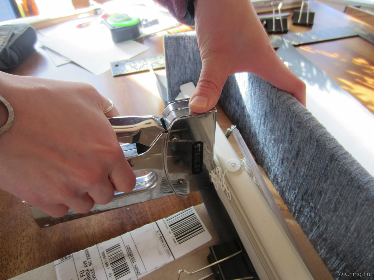 I used a staple gun for the side that the fabric folded over wood.