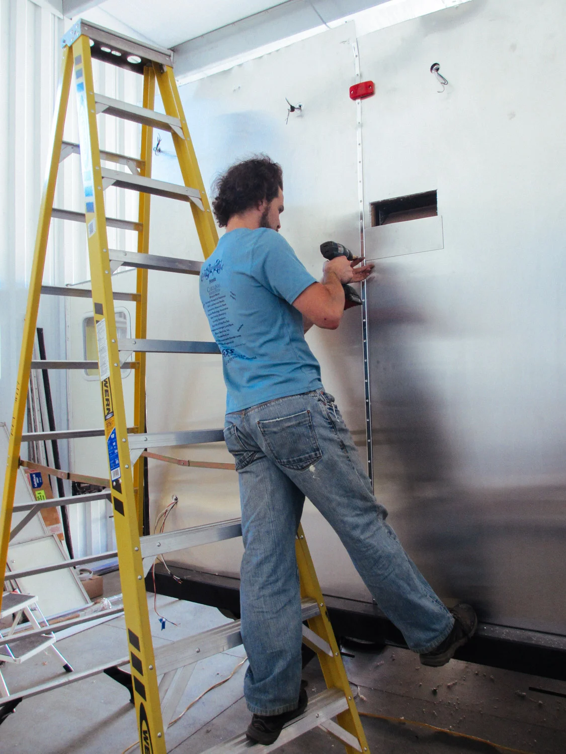 These metal seams were then screwed into the aluminum siding. It was a two-person job to get the metal seams in place and start screwing.