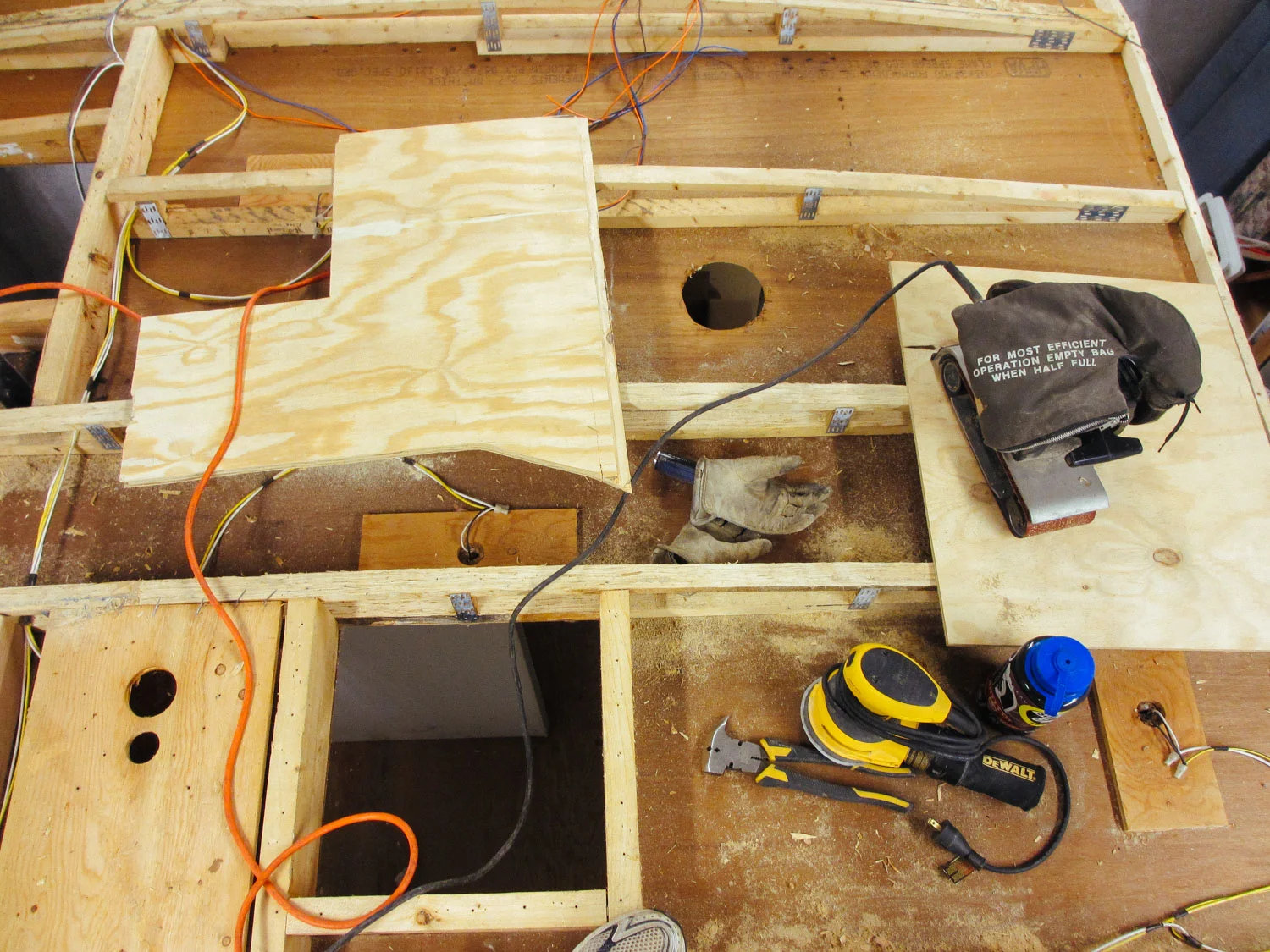 The old adhesive had to be sanded off each roof beam to prepare it for new decking.