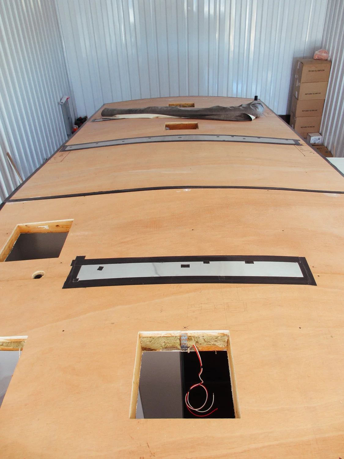 Pieces of aluminum sheets were screwed in over sections of the roof decking where the plywood couldn't be drilled into the beams. We then covered all the metal edges and screw heads with Gorilla tape to protect the rubber roof.