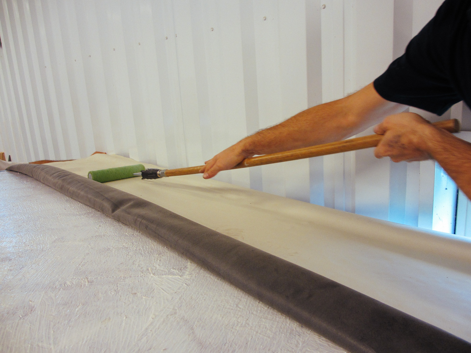  The rubber roof membrane was then rolled out and we used a paint roller to smooth it. 