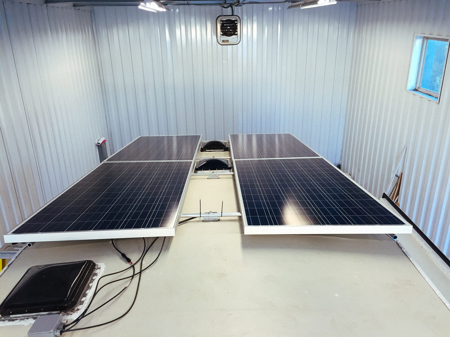  Four 305 watt solar panels installed on the rack. 