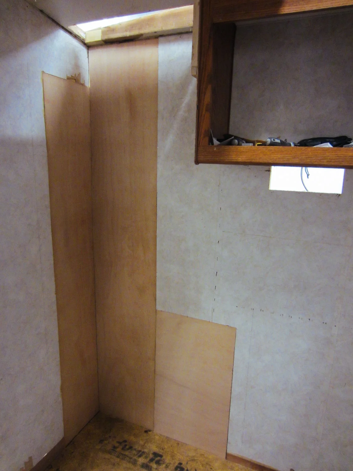 The rotten walls behind the fridge were patched.