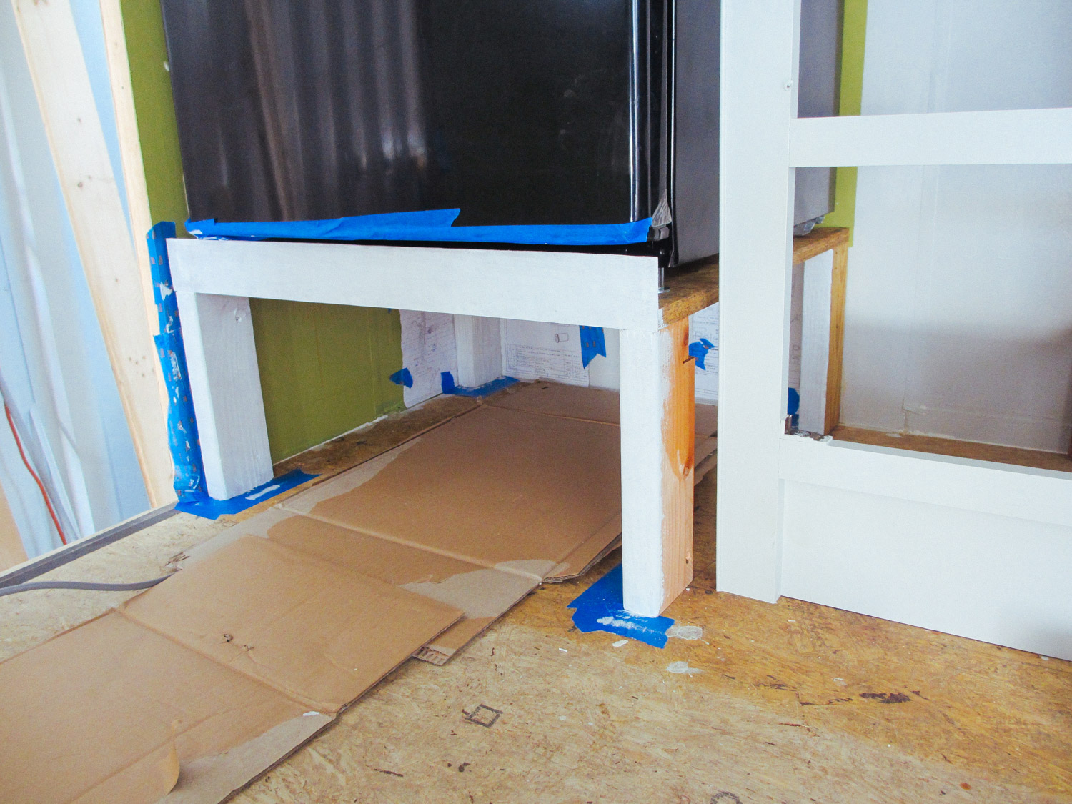  We built a stand for our new residential fridge, which is also a spot for our shoes when we enter the Toaster. 