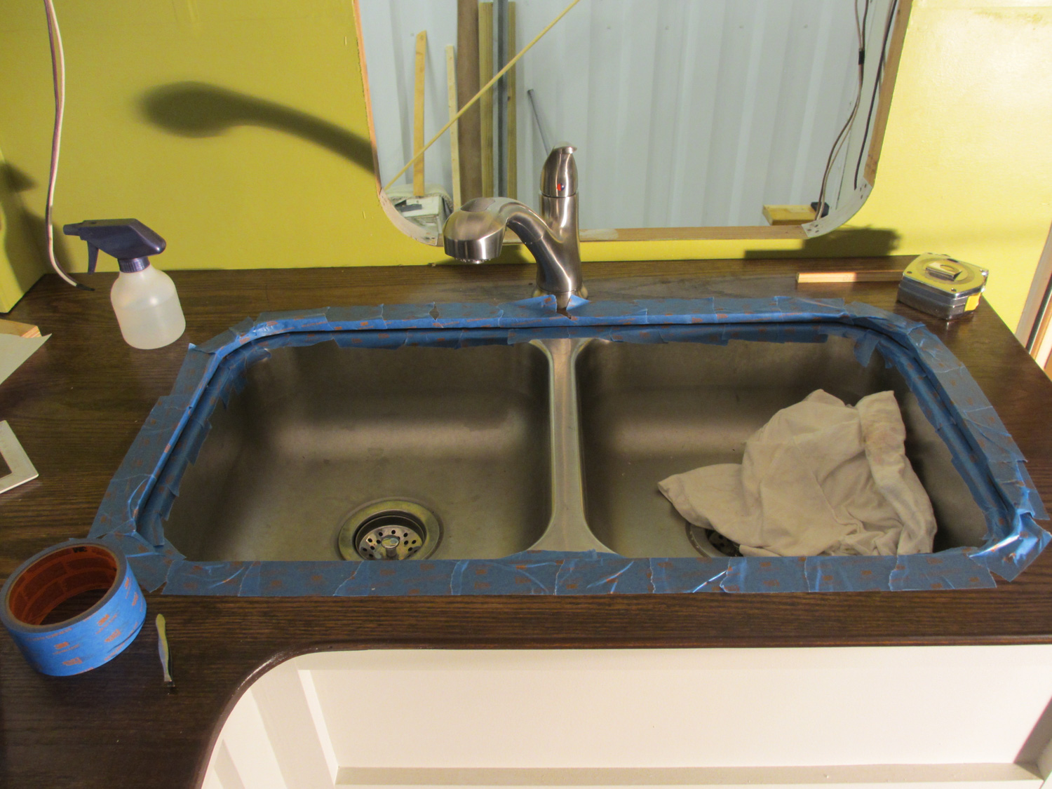  The countertop and kitchen sink were taped off for caulking. 