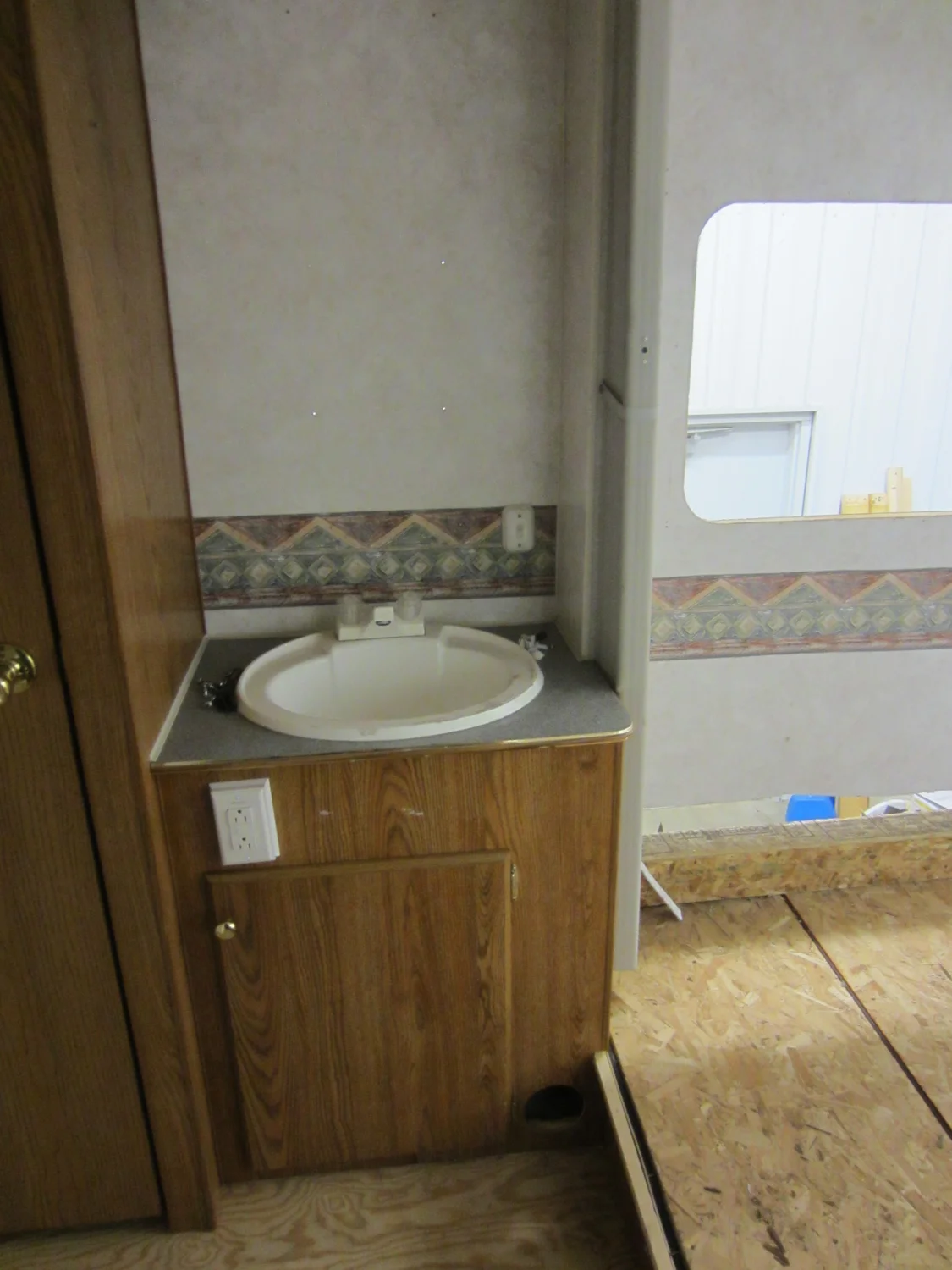 The original bathroom cabinet. It sits across from the shower, at the foot of the bed.