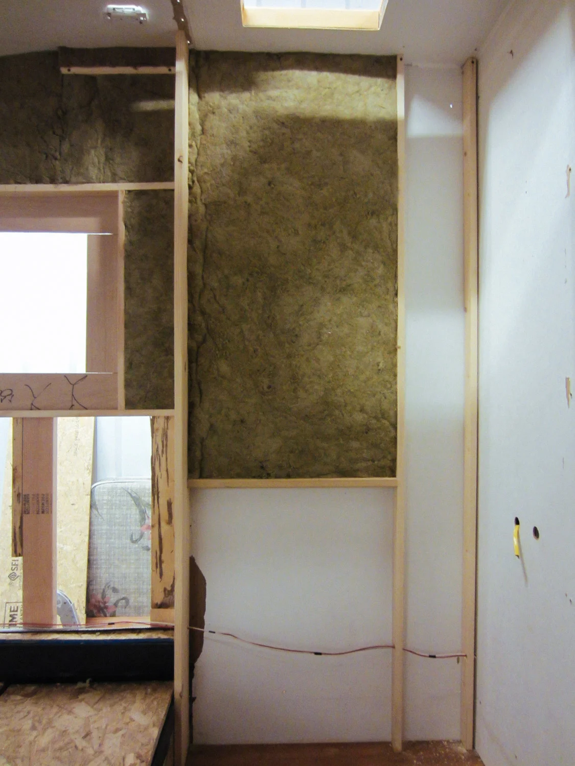We added studs to the shower wall so we could insulate that space with mineral wool.