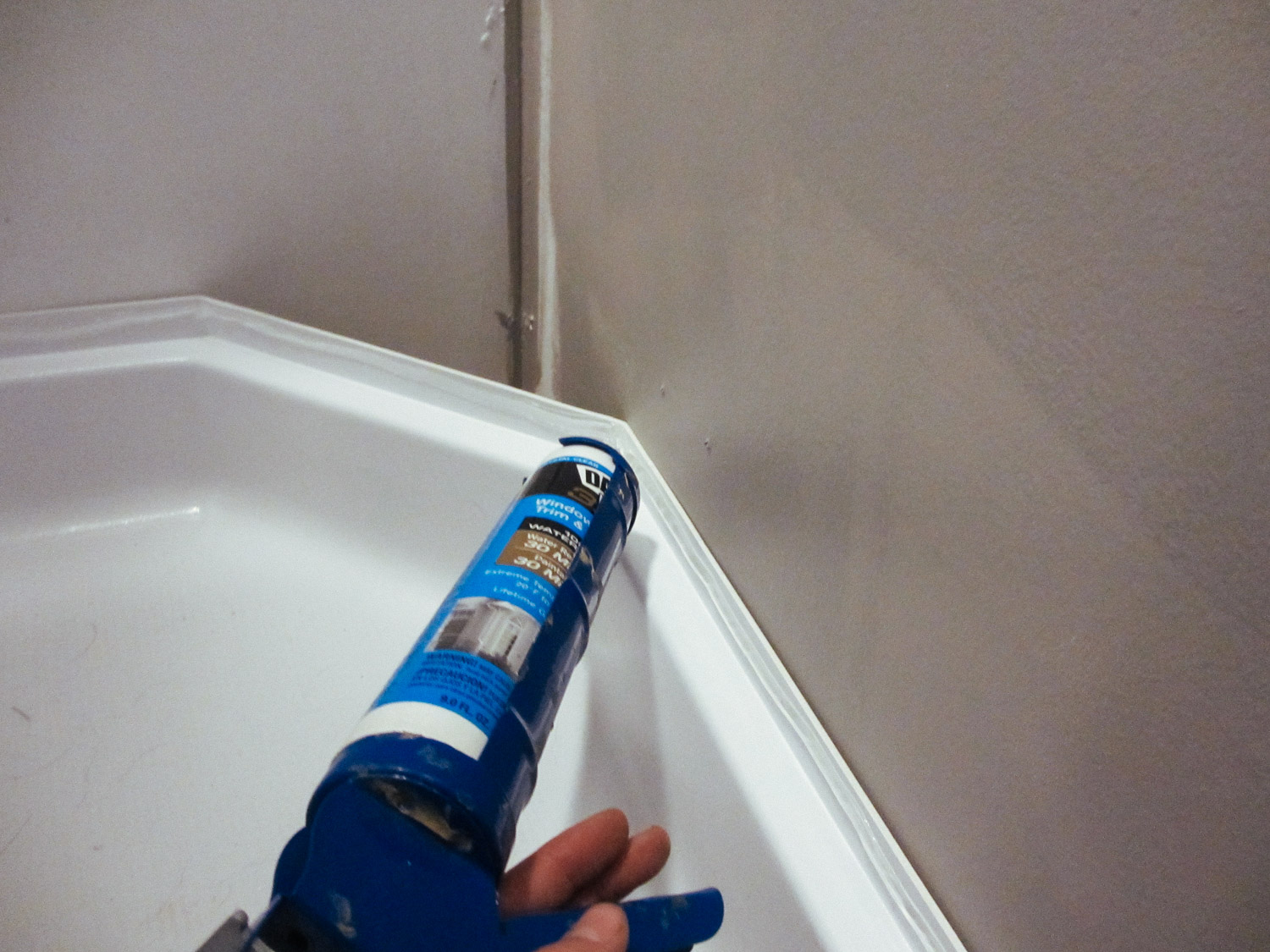  We caulked the top of the shower pan so it would adhere to the shower walls. 