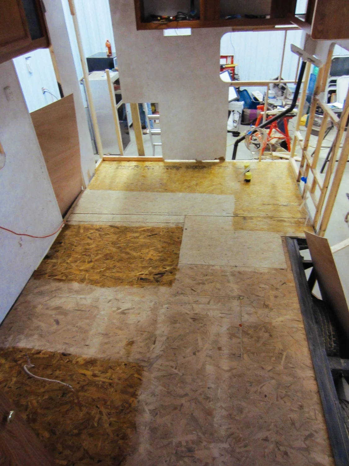 We applied polyurethane to the sections of the sub-floor that wouldn't have laminate floors installed over them. This is where the kitchen cabinet, dinette seats, and the couch are.