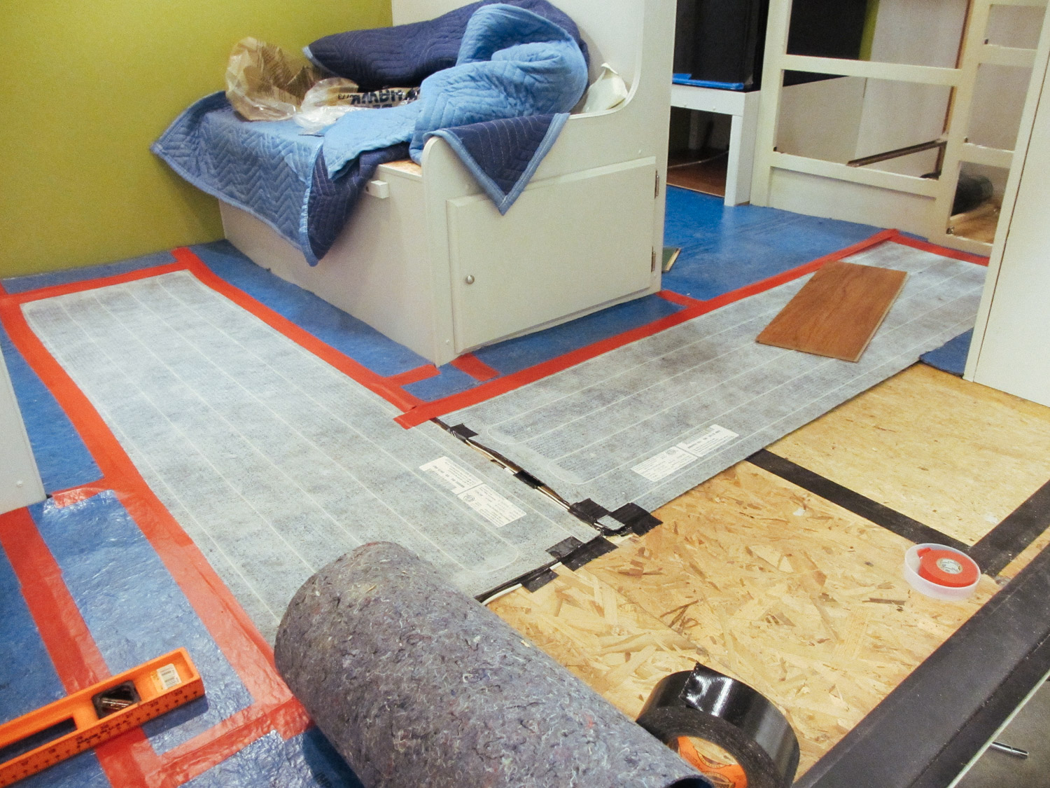  We placed floor heating pads between the dinette seats and in the kitchen area instead of underlayment. 