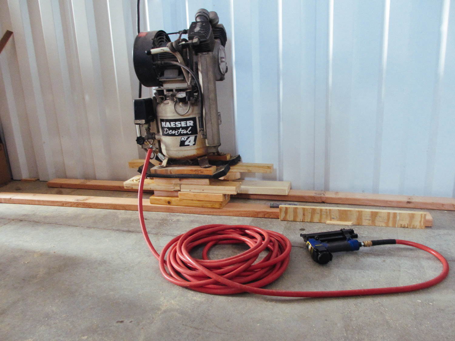  We borrowed an air compressor nail gun to nail the floor trim pieces. 