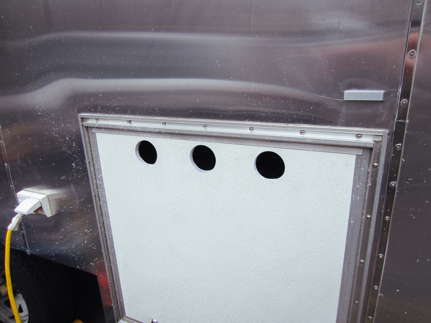  We drilled vent holes into the compartment door to keep the batteries cool and vent battery gases. 