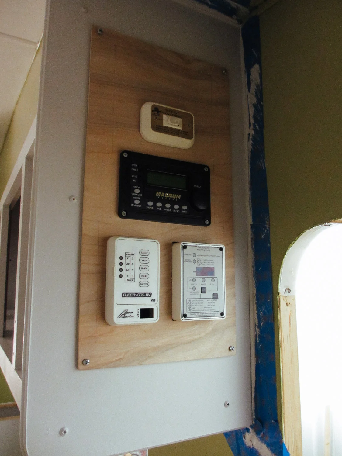 Our first version of our control panel included (top to bottom): slide control, inverter control, tank level sensors (left), and Trimetric battery monitor.