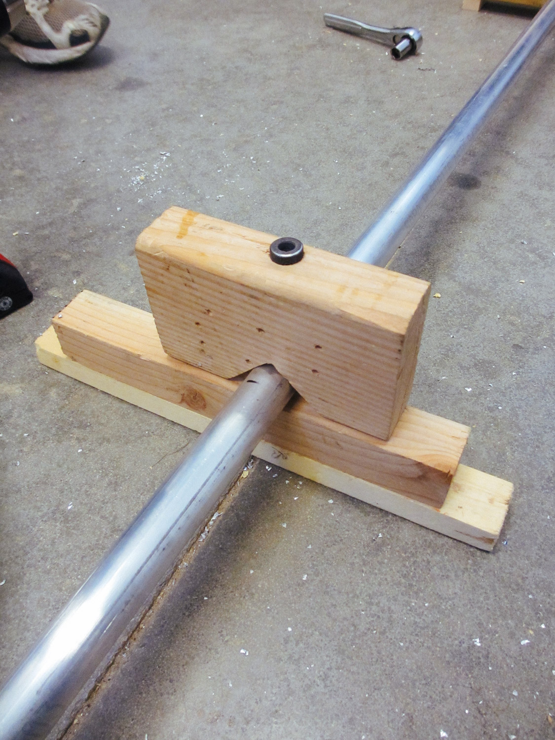  Using a jig to drill the round tubing straight. 