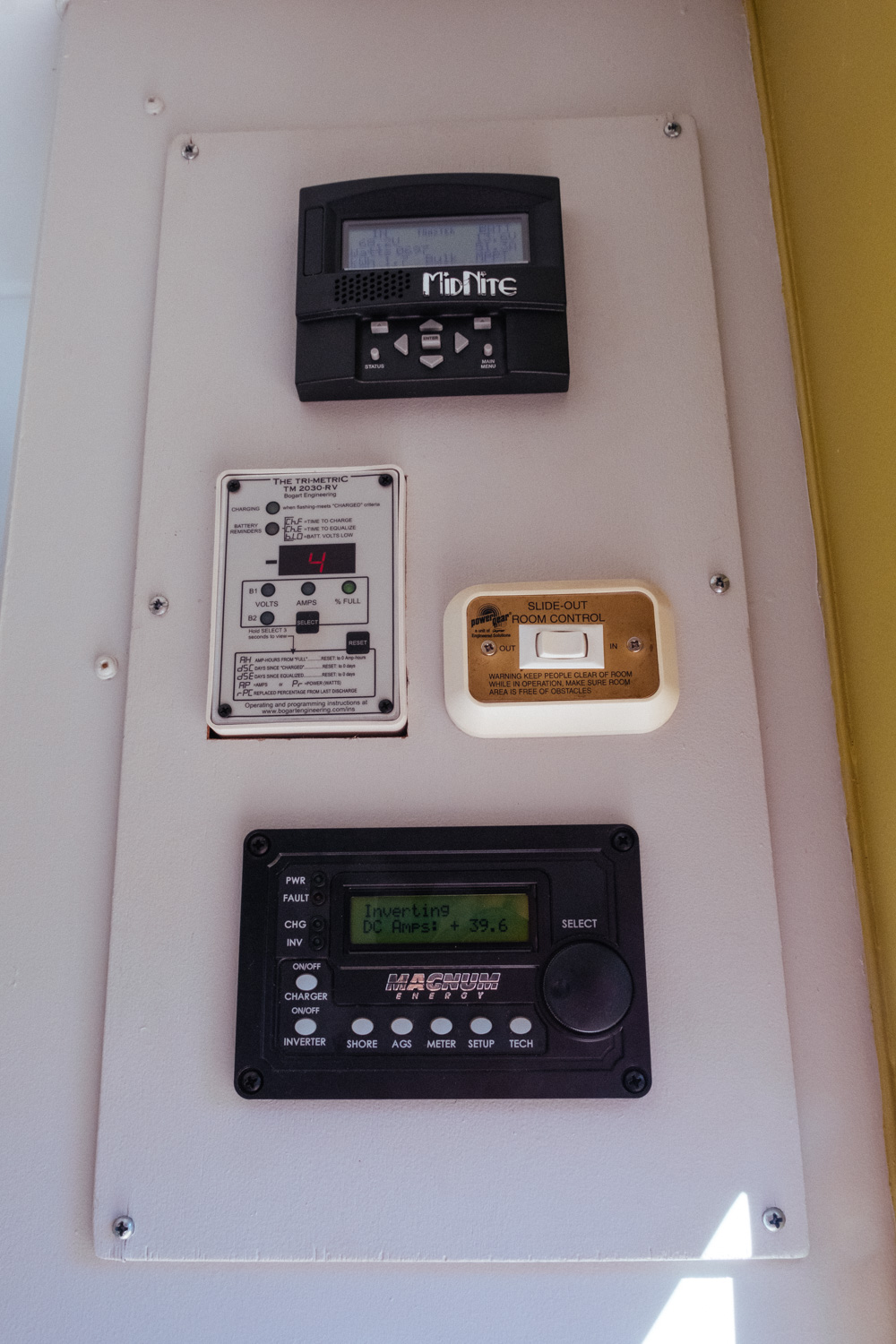  This is our current control panel layout (top to bottom): Midnight Solar remote display, Trimetric battery monitor, slide control, and Magnum inverter remote. 