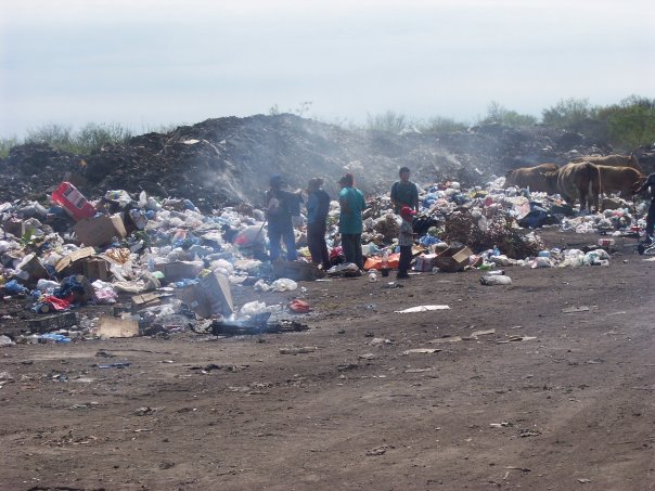 Men, woman, and children were digging through piles of burning trash, releasing toxic chemicals into the air. There were also cows, crows, and dogs walking through the trash looking for food. 
