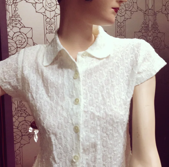 Light lace blouse becomes even lovelier paired with the pretty pink flower pendant below.