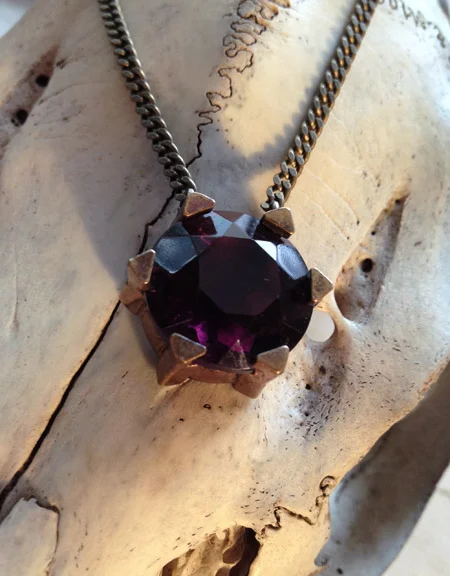 Reincarnated victorian glass pendant set in a unique base.