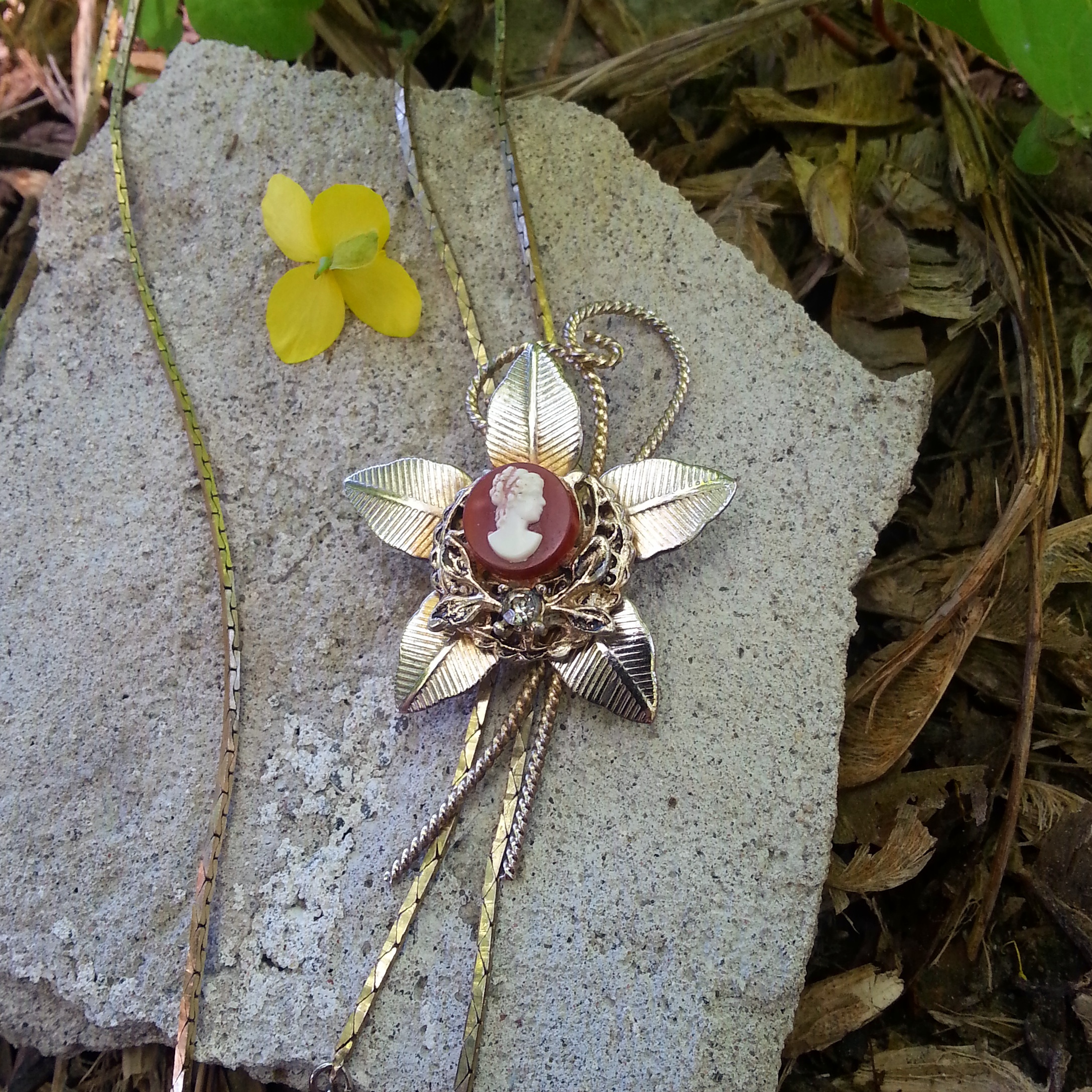 I love a good slider, this one is an ultimate one of a kind item, adorned with a pretty mini cameo with filigree details!