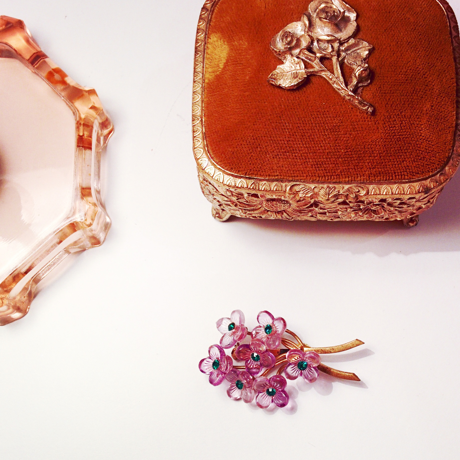 Love this violet floral brooch with green rhinestone detail!