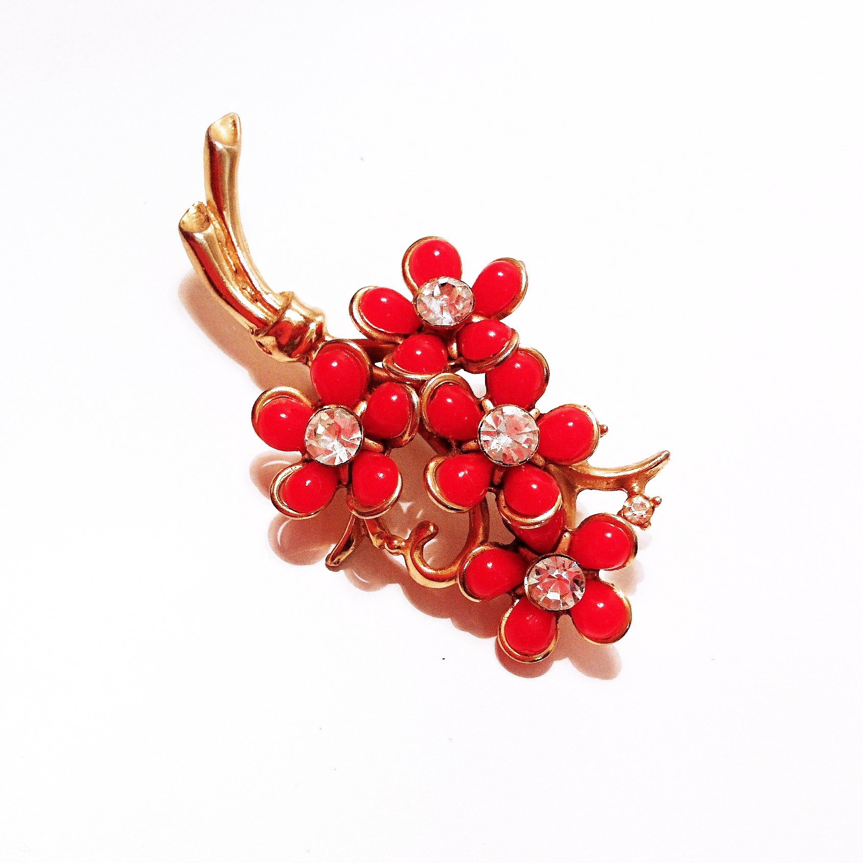 A fantastic red floral brooch with rhinestone detail, ready to add a little spring to your step!