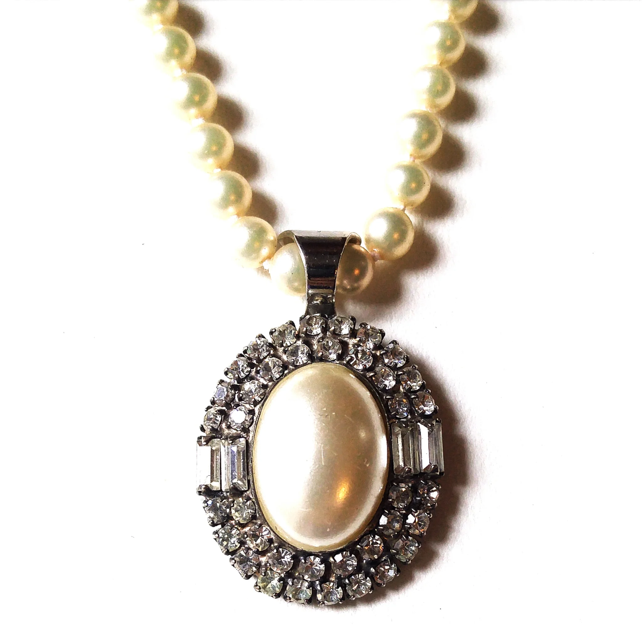 Gorgeous vintage rhinestone clip on earring, converted to a one of a kind pendant and set on a strand of high quality deadstock vintage pearls