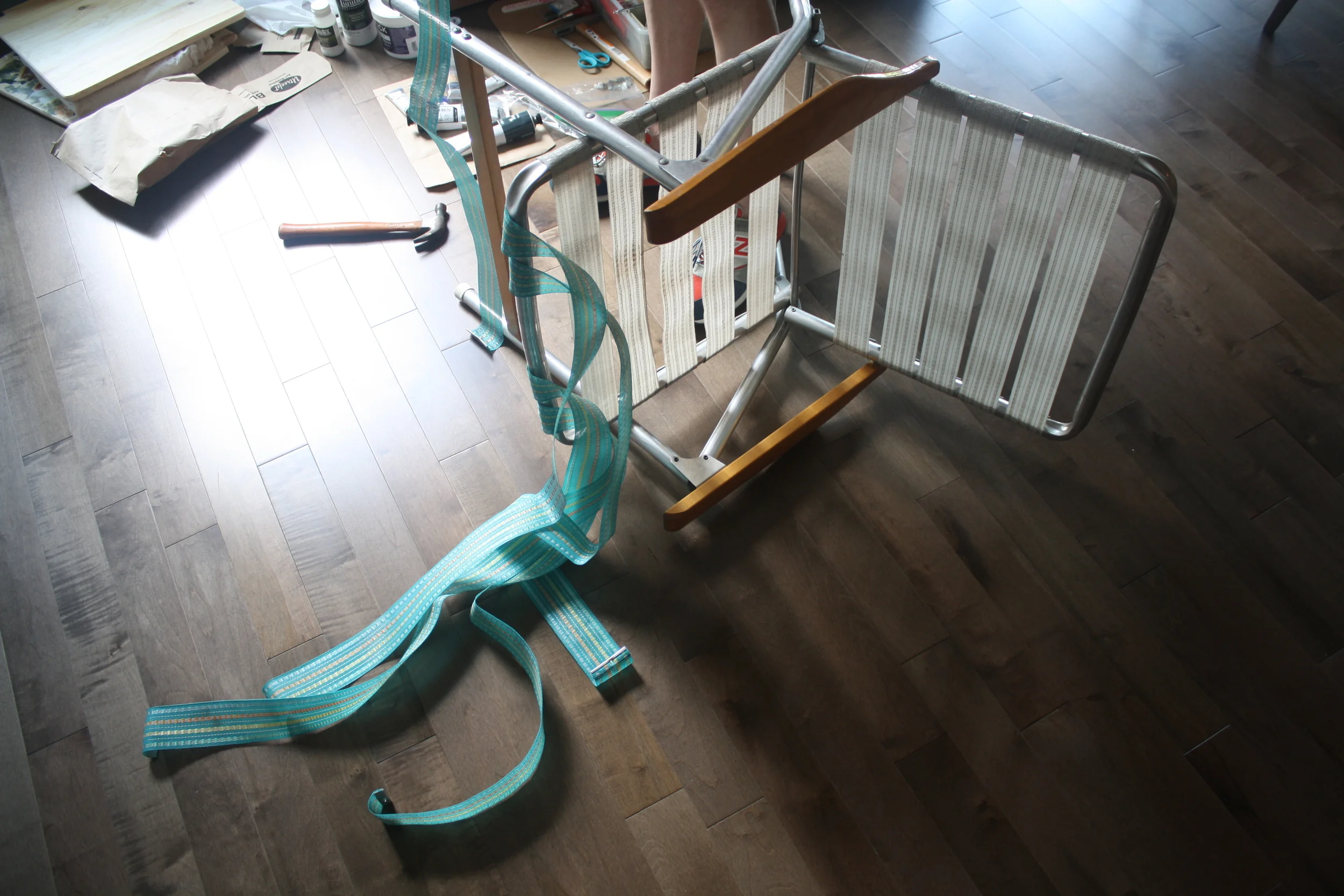 First step is to disassemble the chair by unscrewing the canvas strips. Discard all but one from each direction to use as a template.