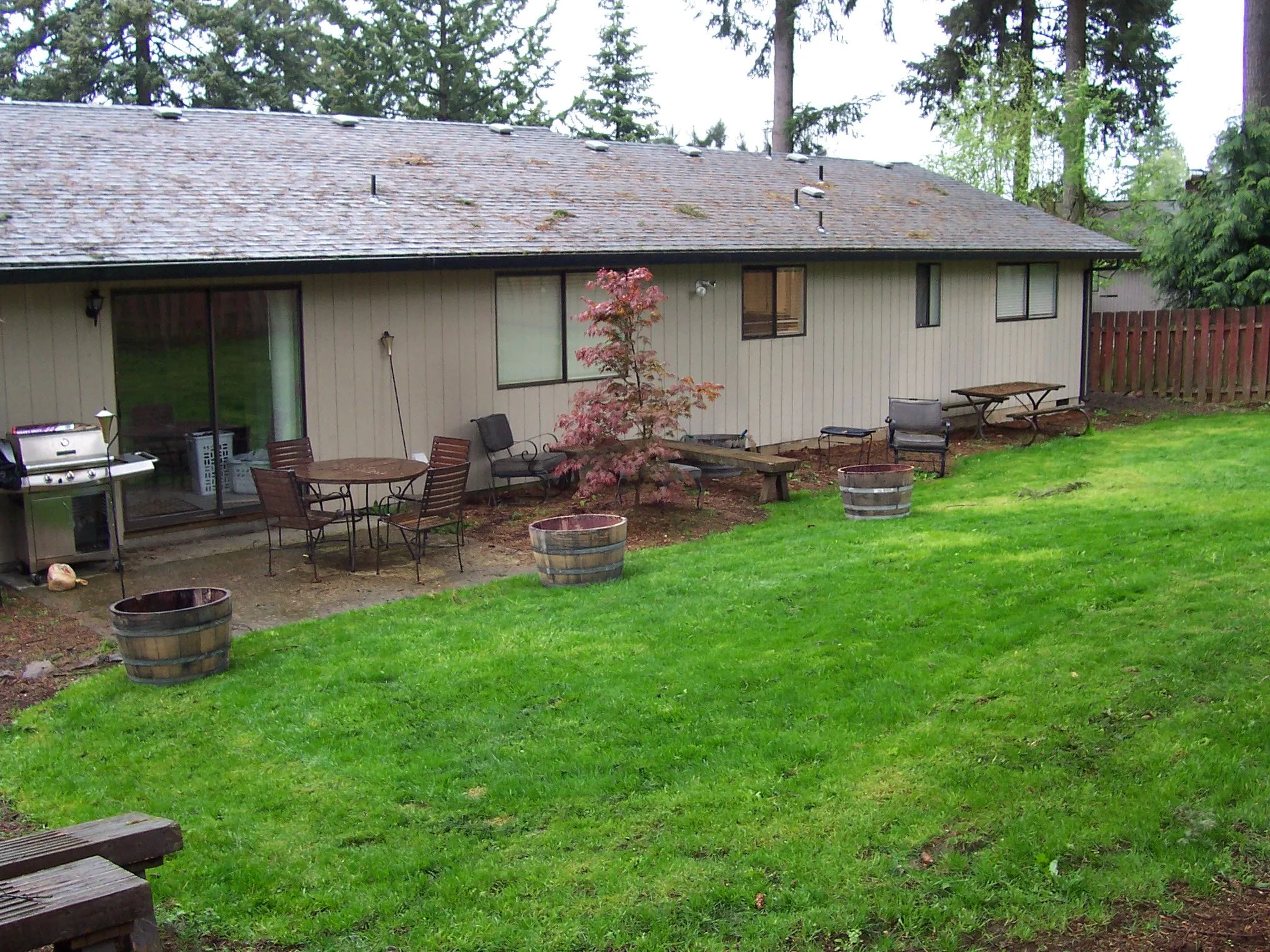  A look down at the small afterthought of a concrete pad patio. 