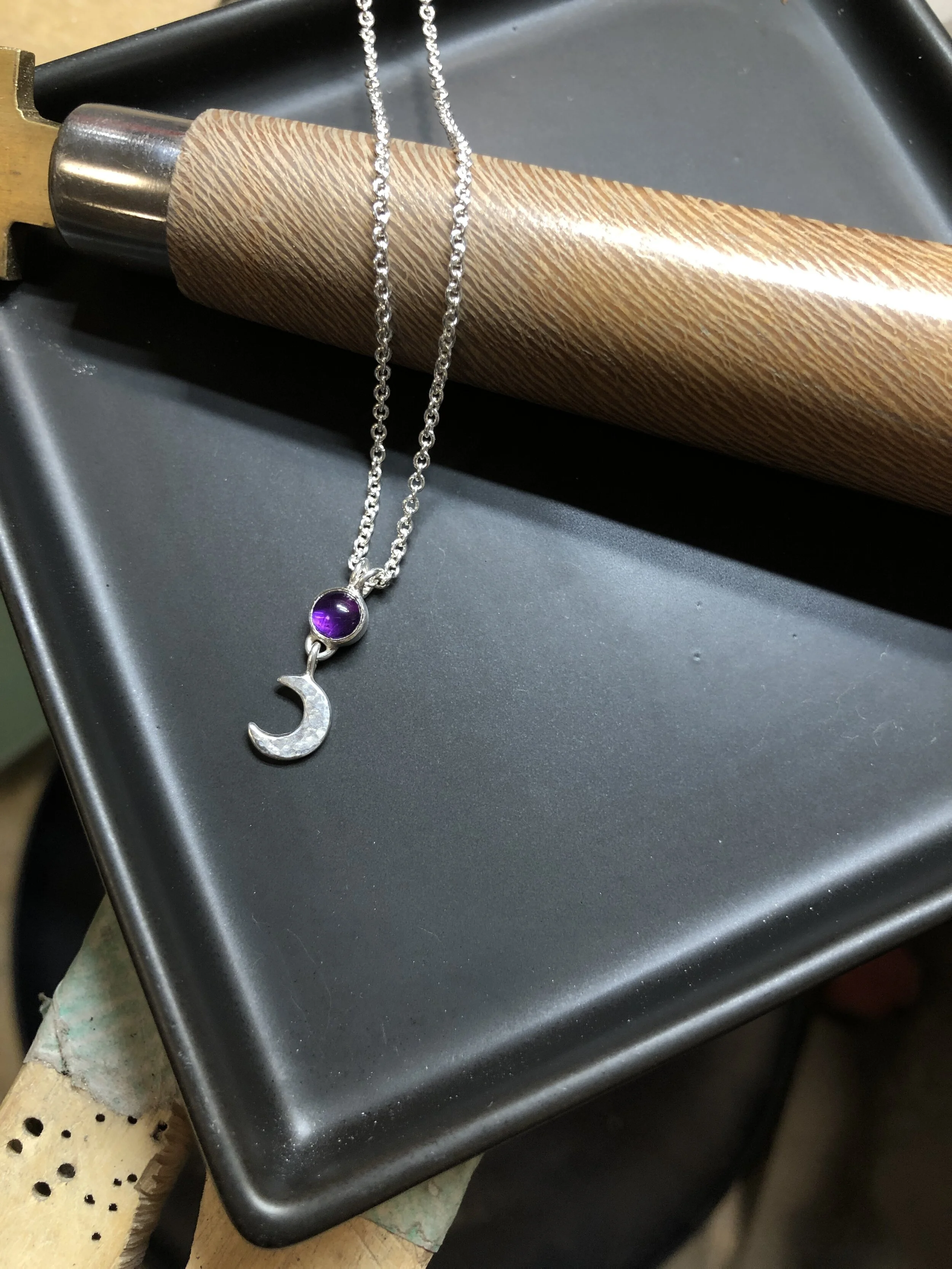  This sweet Crescent Moon Pendant was made with Amethyst set in sterling silver 