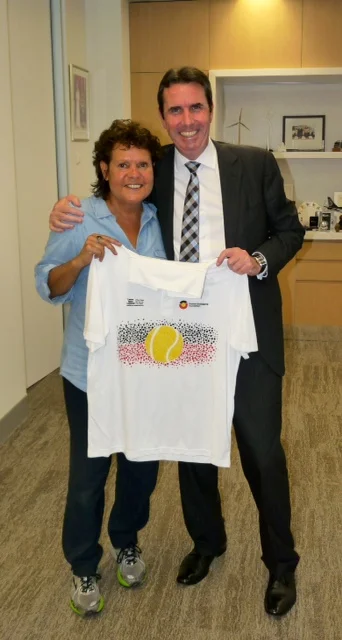 Evonne presenting Mr Peter Collier the Western Australian Minister for Aboriginal Affairs with an Evonne Goolagong Foundation Shirt.