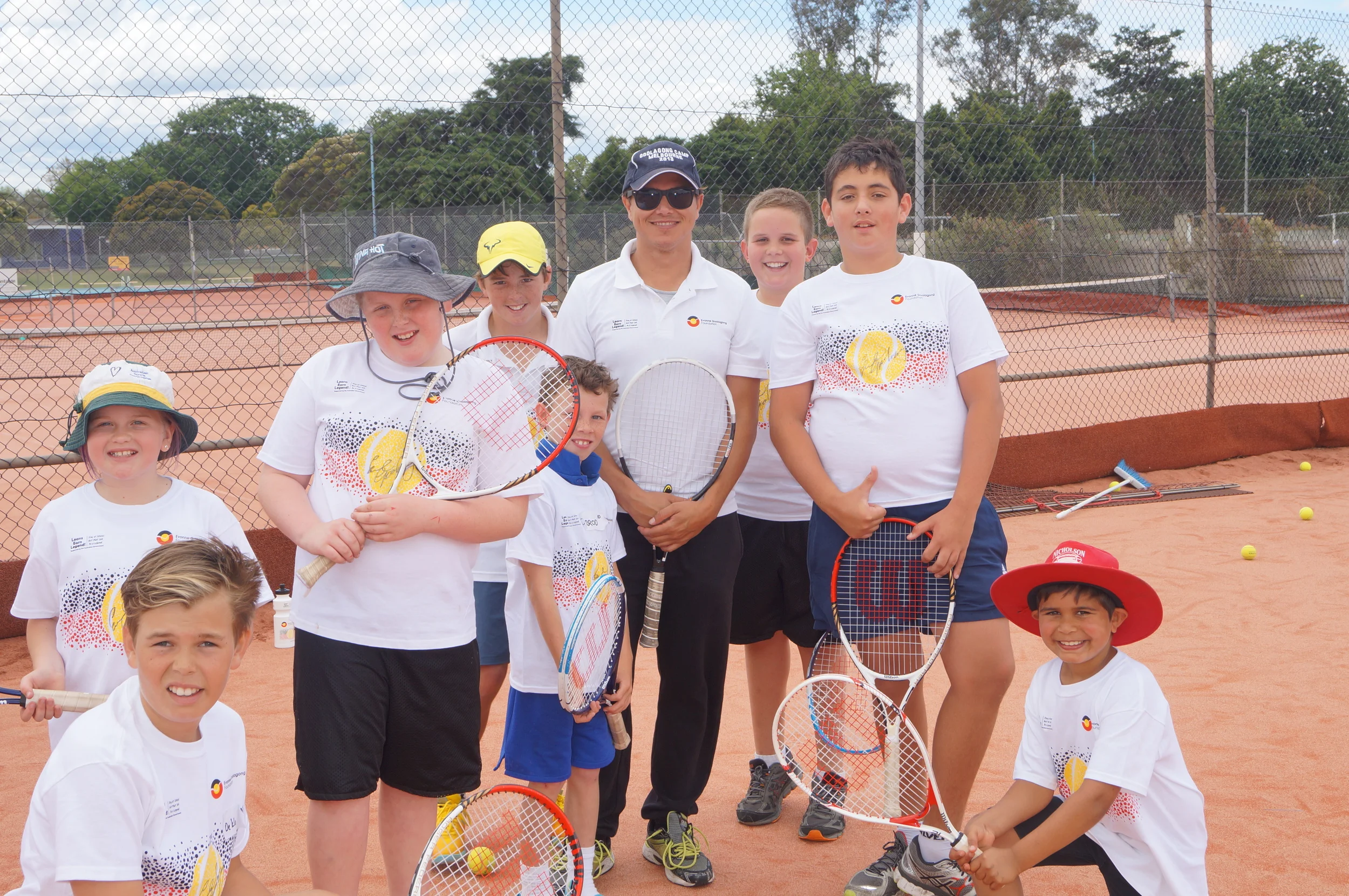Evonne Goolagong Foundation Head Coach Anzac Leidig with some happy players including local Toby Radford (yellow hat) who has been selected for the Goolagong National Development Camp 2015. Congratulations to all on giving of their best. 