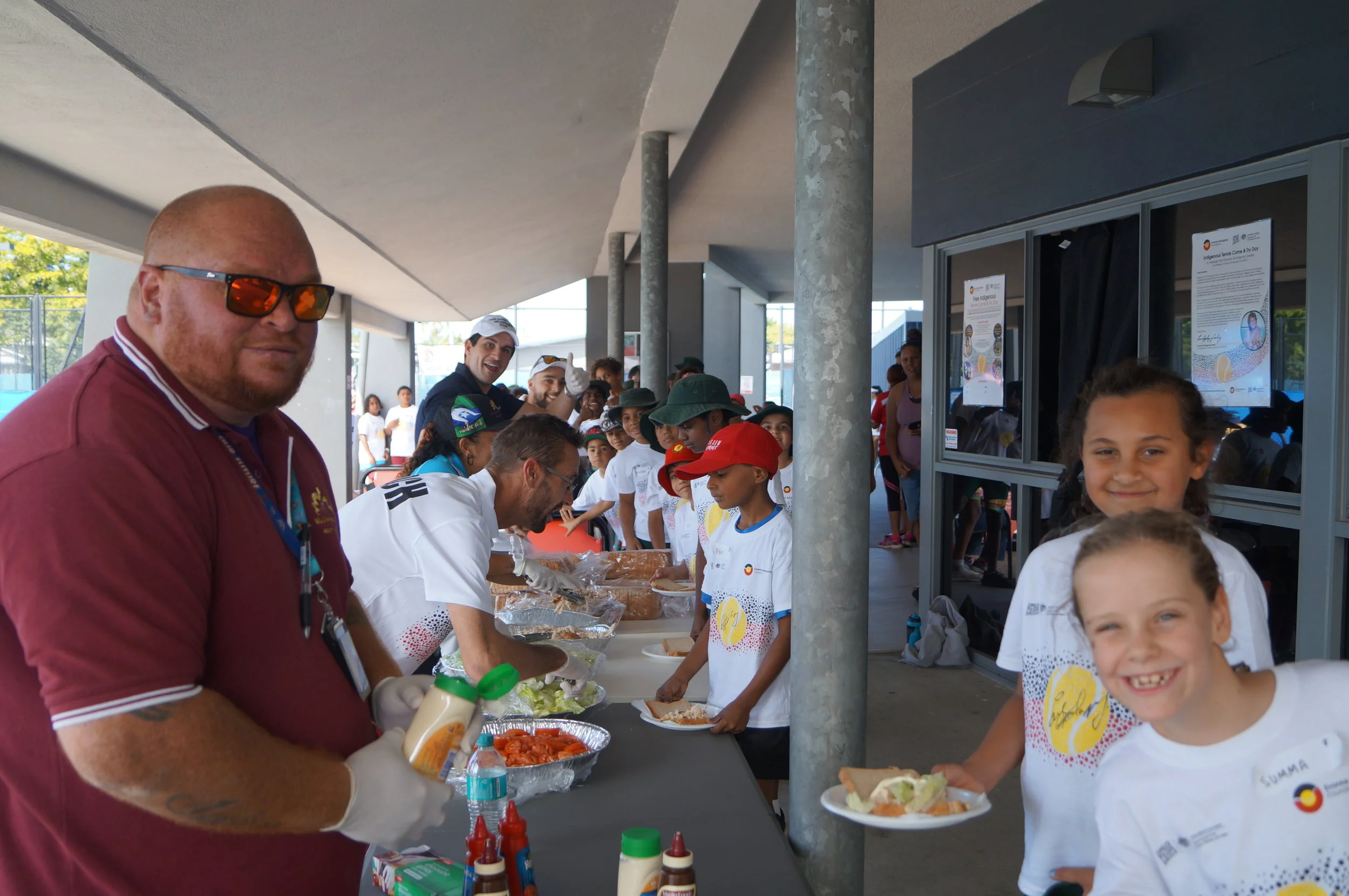 Wuchopperen Health Service help us serve lunch to the happy, hungry kids”
