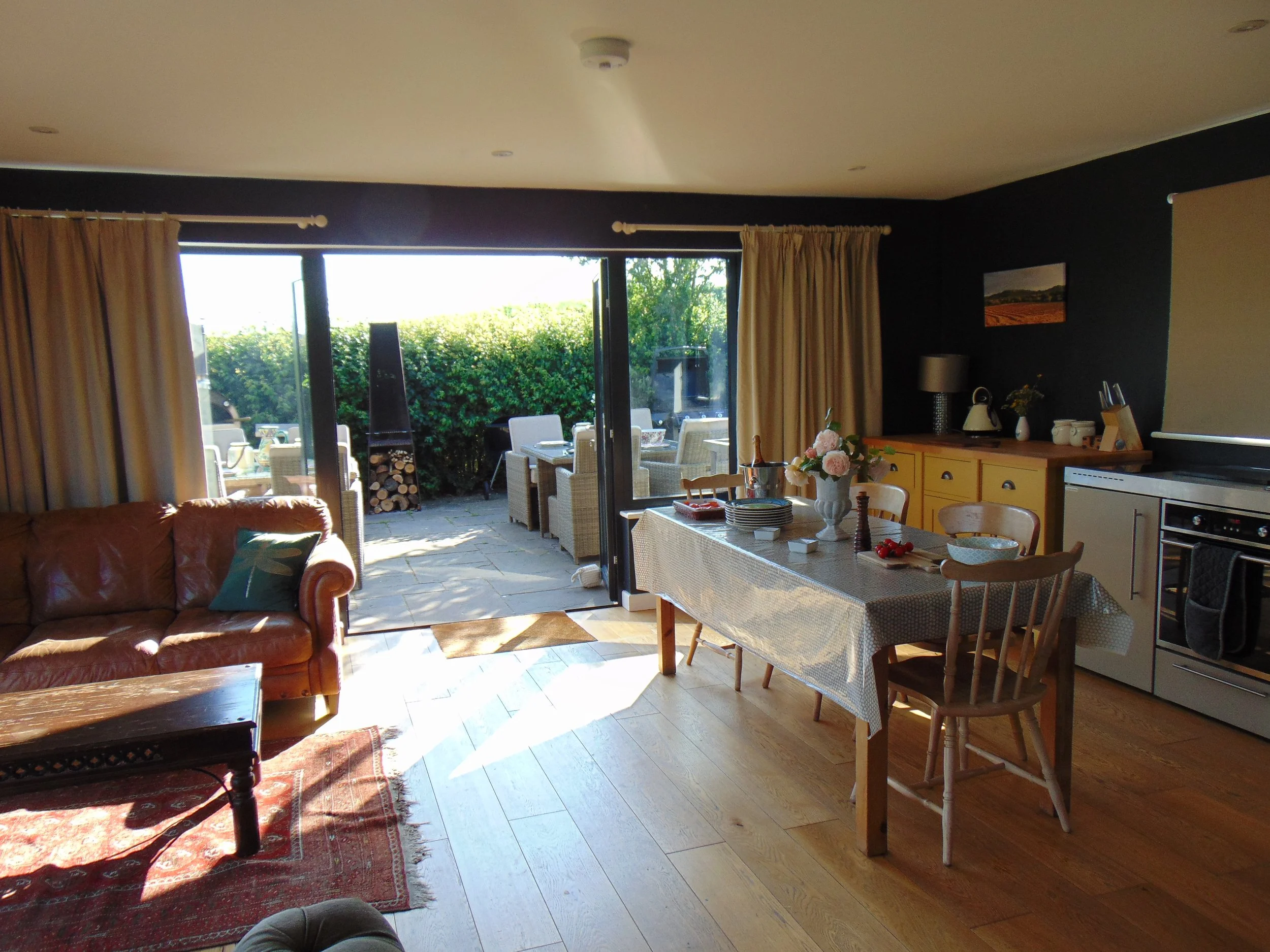 Summer House sitting room with doors open to firepit.JPG
