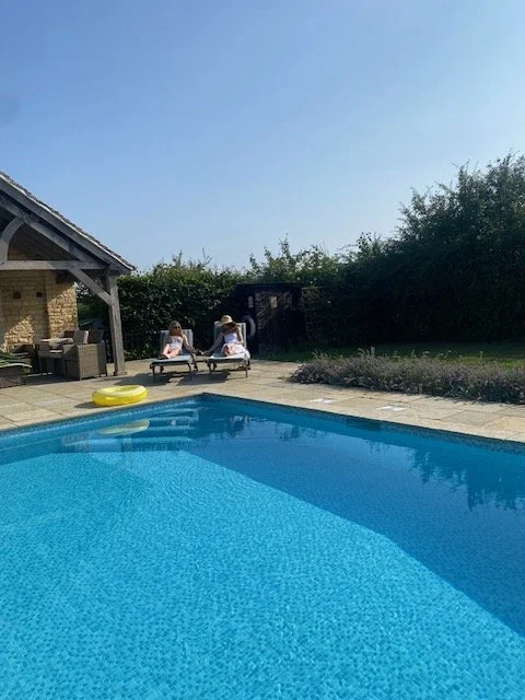 F and mother seated by pool.jpeg