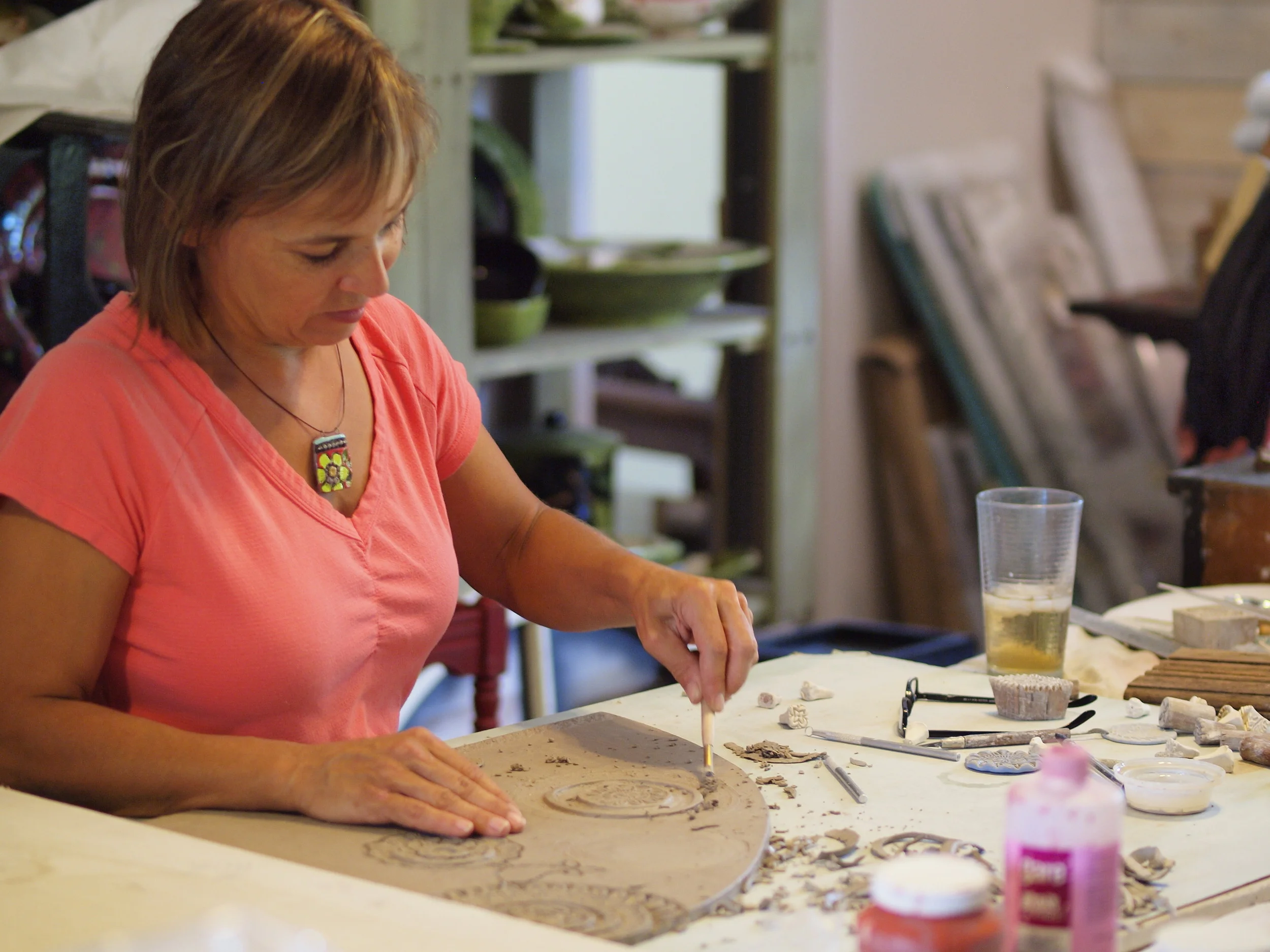 Clare working on raw clay slab