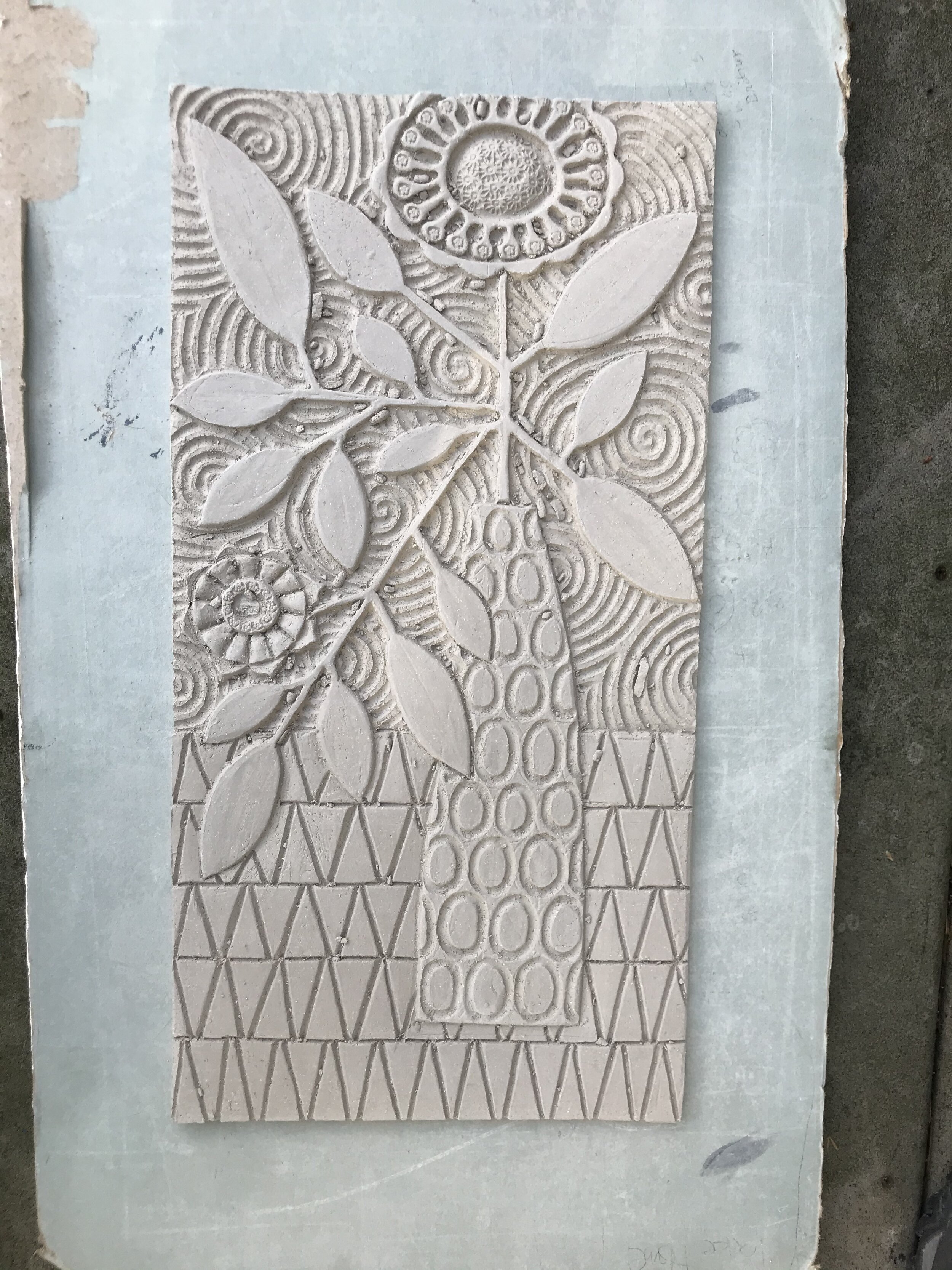 Carved panel in raw clay