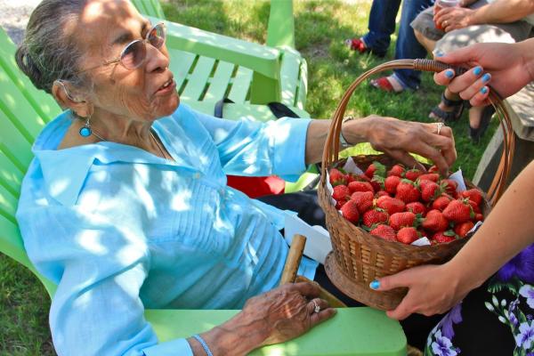 Eleanor Spears Dove, 97, Narragansett elder, sampled a strawberry from a basket passed at the Narragansett Strawberry Thanksgiving.