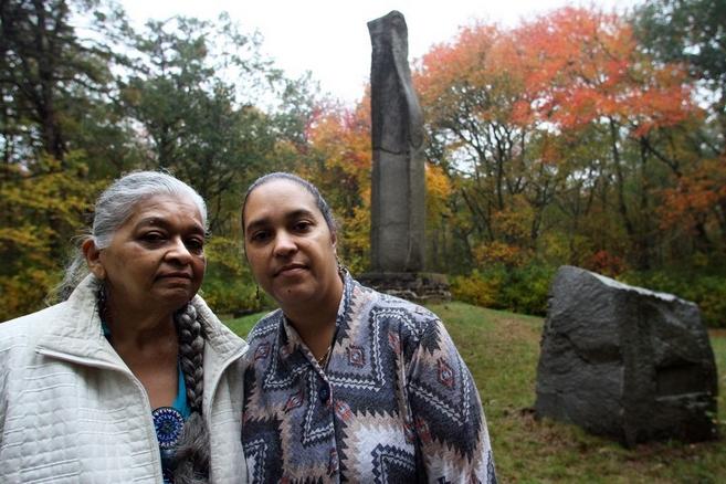Paulla Dove Jennings, left, and Loren Spears, next to the Great Swamp Massacre Monument in South Kingstown. The Providence Journal/Bob Breidenbach