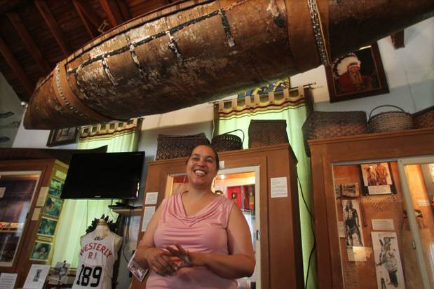 Executive Director, Lorén Spears of Tomaquag Museum, in Exeter Rhode Island stands in front of a Traditional Narragansett Birch Bark Canoe.