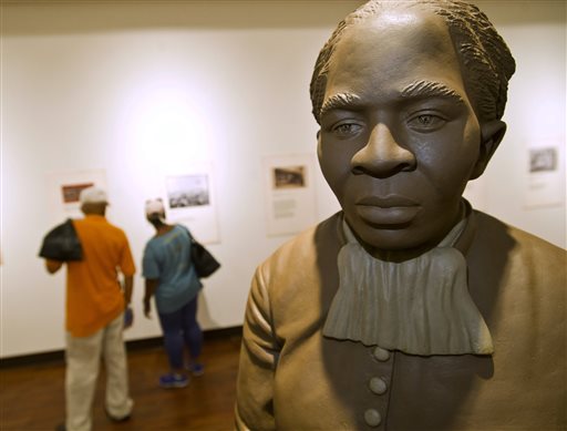 A statue of Harriett Tubman is the centerpiece of the History Gallery at the Tubman Museum, Wednesday, April 20, 2016, in Macon, Ga. Tubman, a prominent anti-slavery activist, will be the first African-American to appear on an American banknote and the first woman to appear on one in a century. Her portrait will replace former President Andrew Jackson, who will be moved to the back of the redesigned $20 bill. Ezzell and Beverly Hart Pittman from Columbia, SC, visit the museum Wednesday afternoon. (Woody Marshall/The Telegraph via AP