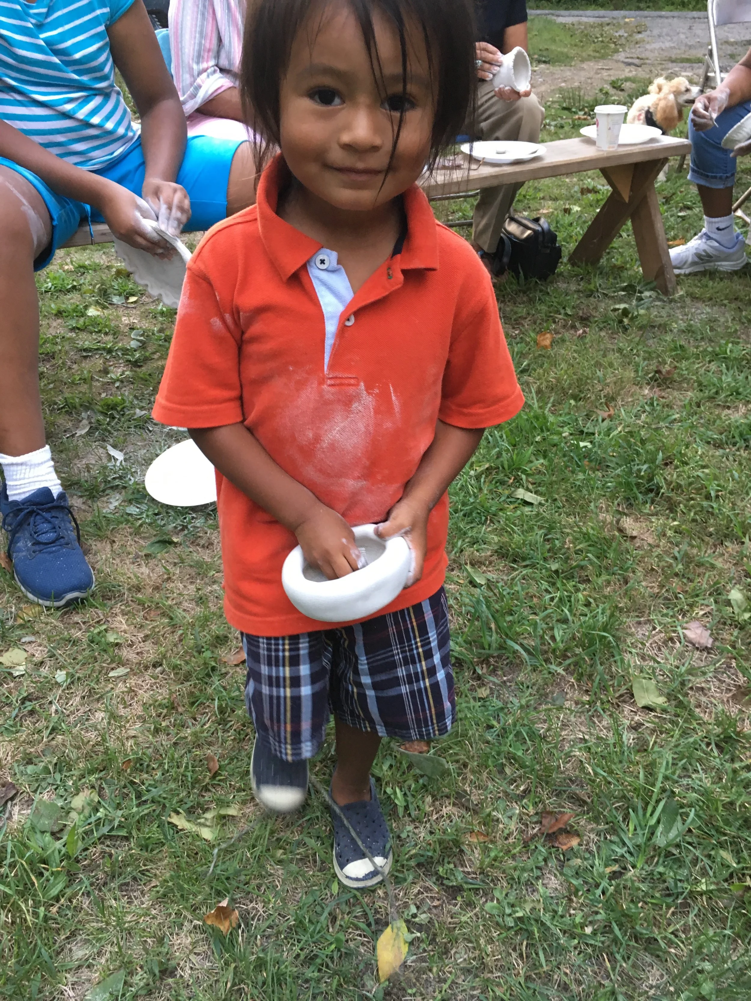 Nikosis LaRose, Narragansett/Ute, polishes a newly made clay bowl