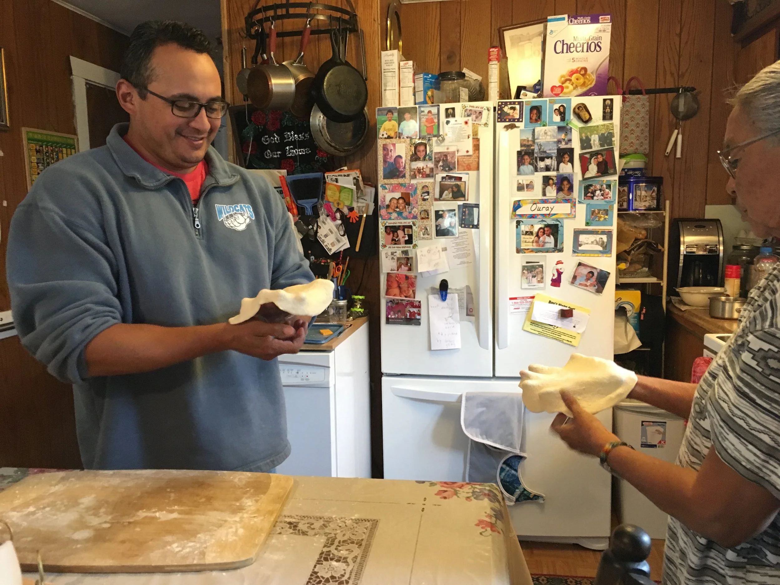 Tomaquag's Marketing Associate, Quanah LaRose learning how to make Frybread from his mother.
