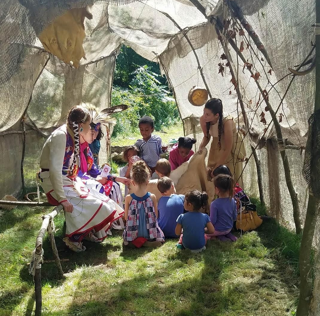 Tomaquag Educator Lynsea Montanari with a group of children during a storytelling program at Tomaquag Museum.