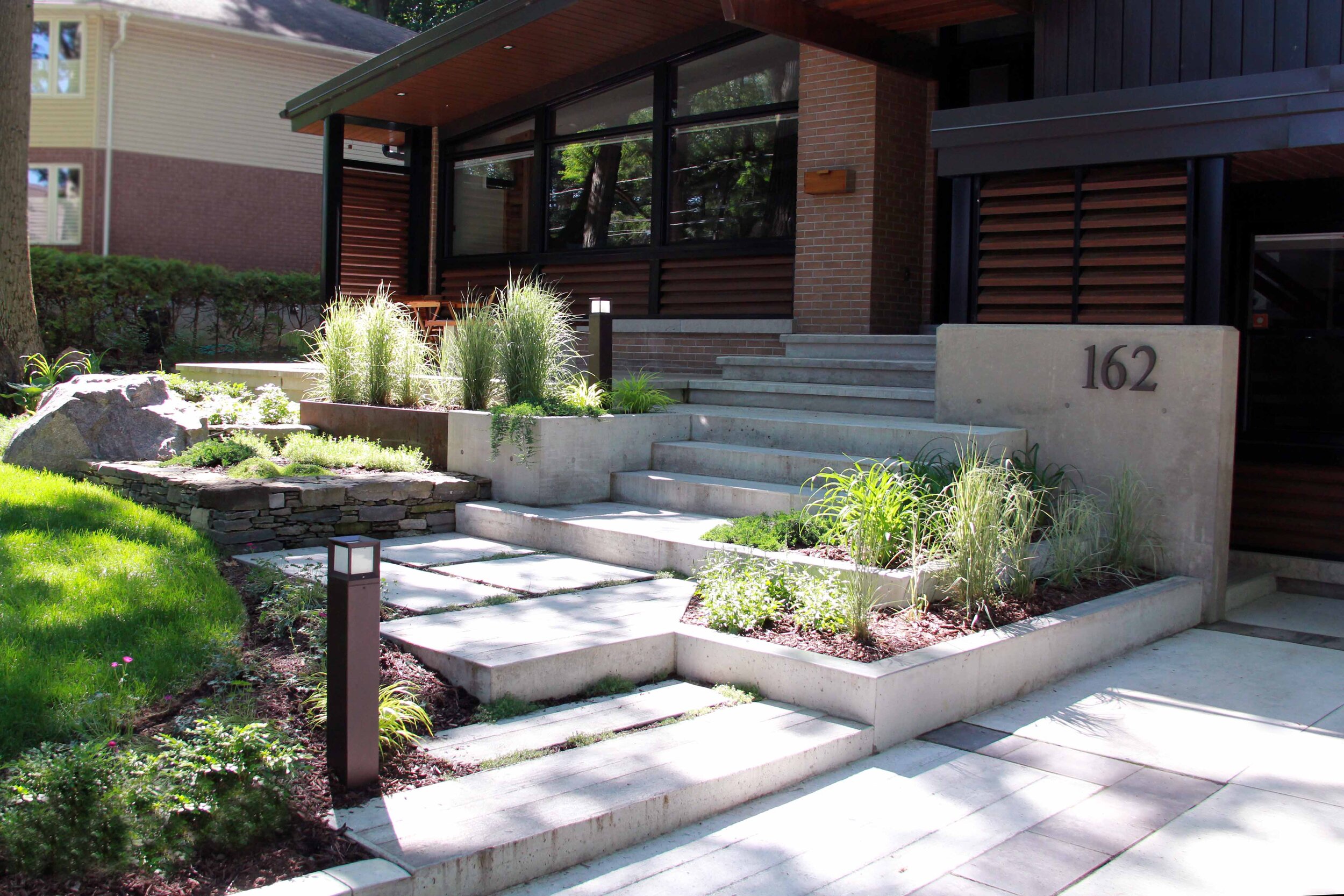 Front entry way-poured concrete driveway- poured concrete- Mid century Modern- Modern elements-Landscaping- Landscape Design-shade screen-privacy screen elements-.jpg