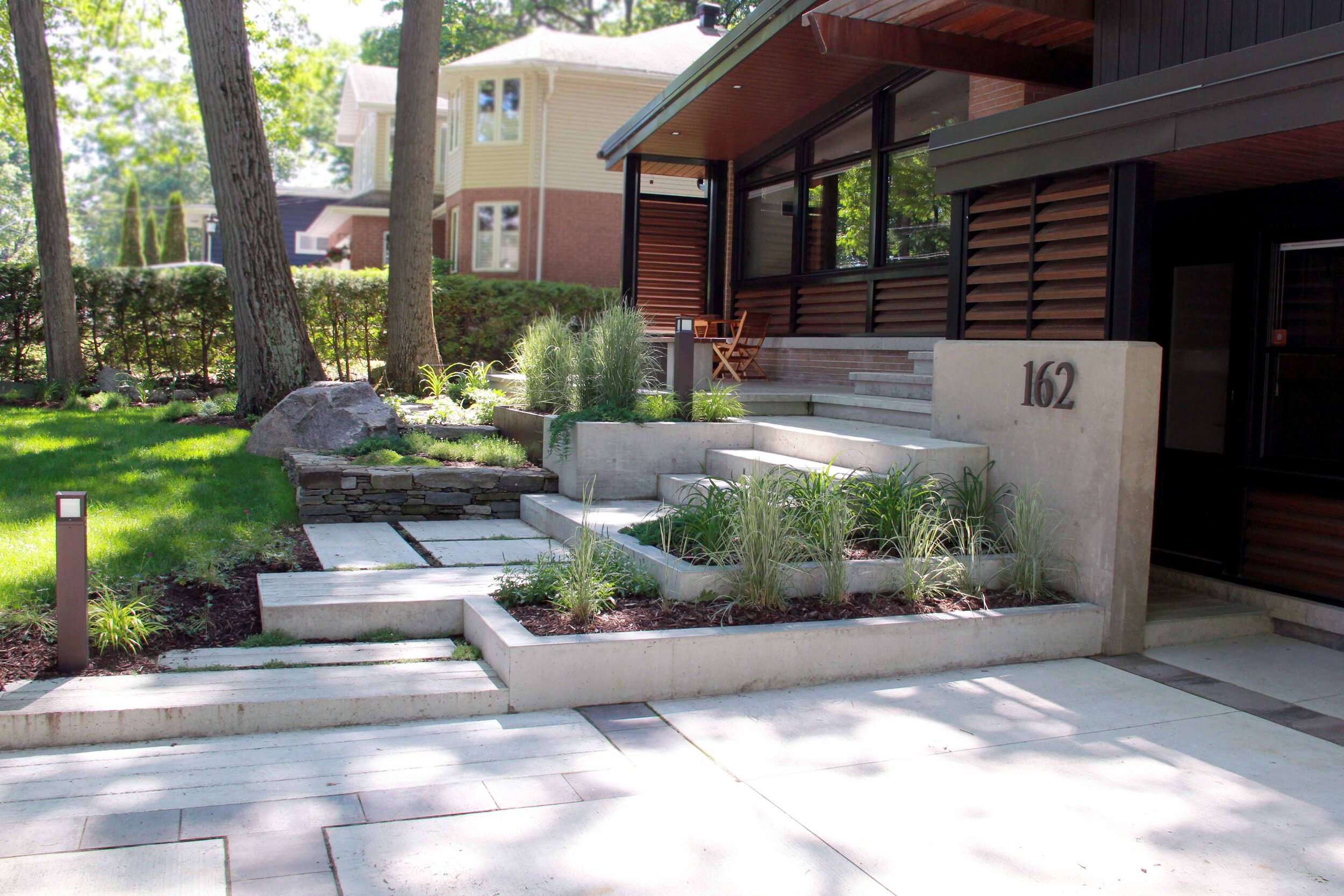 Poured concrete driveway- Mid Century Modern Home- Raised Garden Beds-front walk up- Ipe wood-Patio-Low maintenance garden-Landscape design.jpg